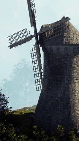 ancient windmill in misty landscape