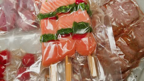 vacuum-sealed raw meats and fish skewers