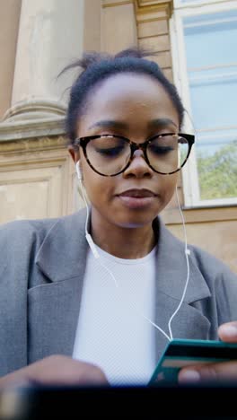 young woman using credit card outdoors