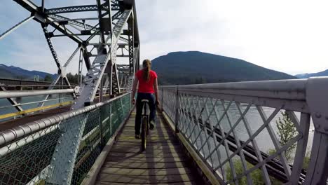 Woman-riding-unicycle-on-the-bridge-4k