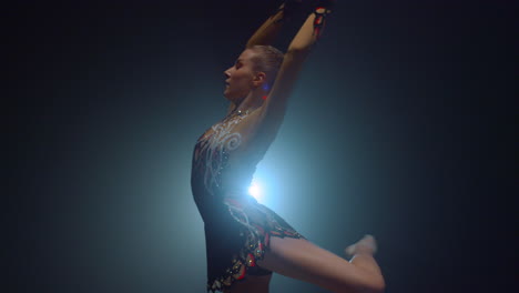 Pretty-sportswoman-doing-rhythmic-gymnastics-indoors.-Beautiful-gymnast-dancing.