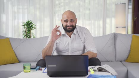 Home-office-worker-man-making-positive-gesture-at-camera.