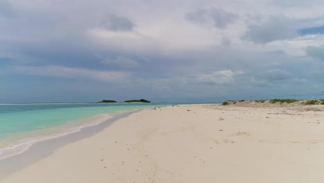 pov watch stunning lonely shore beach with sea birds on white sand island, los roques