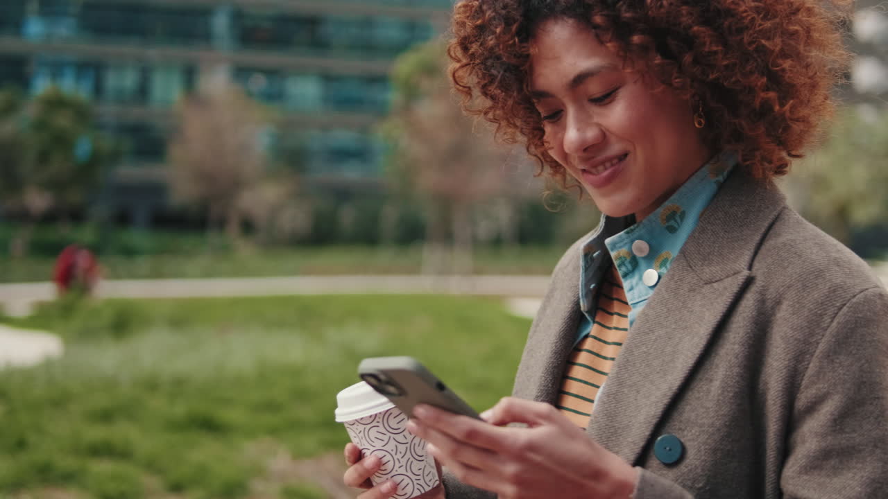 Young Woman Using Smartphone and Drinking Coffee
