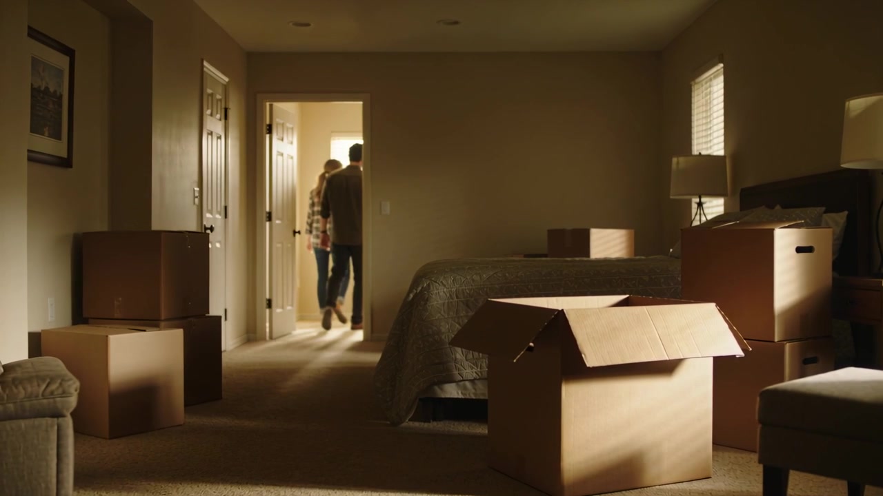 Checking packed boxes, couple leaving bedroom by bed, plaid woman and button-shirted man in jeans