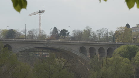 wide shot of pedestrians walking over the adolphe bridge in downtown luxembourg