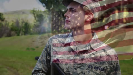 Animation-of-flag-of-america-waving-over-caucasian-male-air-force-soldier-holding-gun