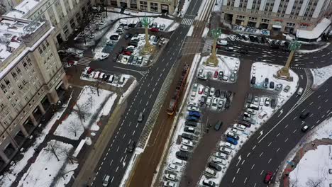 aerial view following a tram on the snowy streets of warsaw, winter in poland