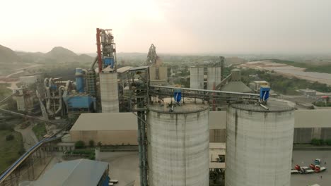 an aerial shot taken by a drone of a large cement manufacturing factory.