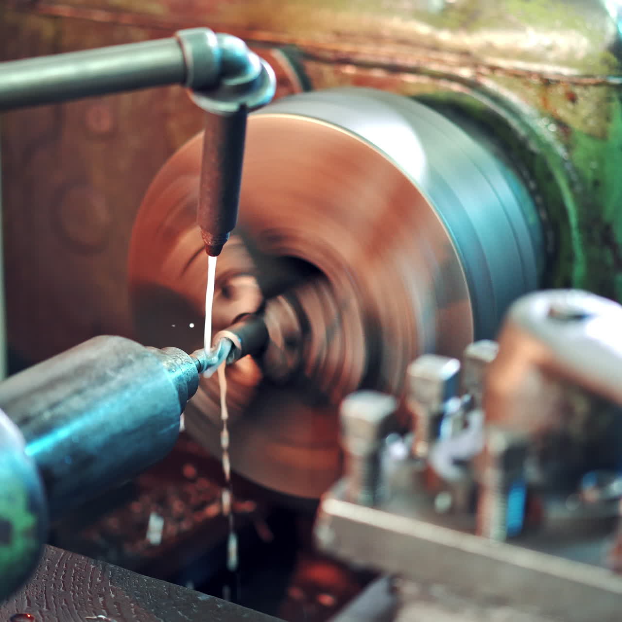 Process of cutting metal in turning lathe on the industrial factory background. Metalworking details and parts on lathe at industrial factory in manufacturing background