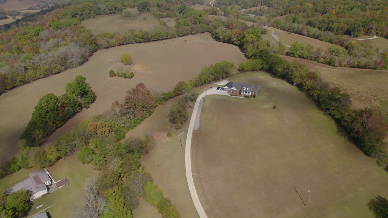 Aerial establishing shot of Tennesee, southeast USA rural landscape with fields and farms in early autumn