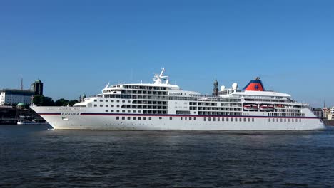 cruise liner in hamburg on departure, elbe and cityscape,