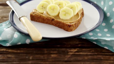 sliced bananas spread on brown bread in plate