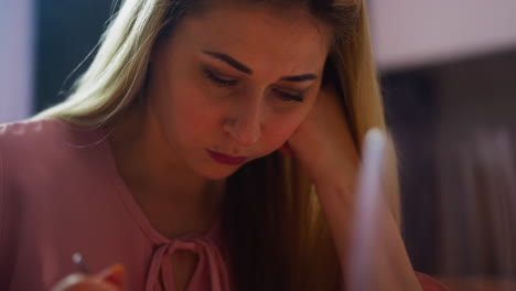 upset woman with absence of appetite picks food at table