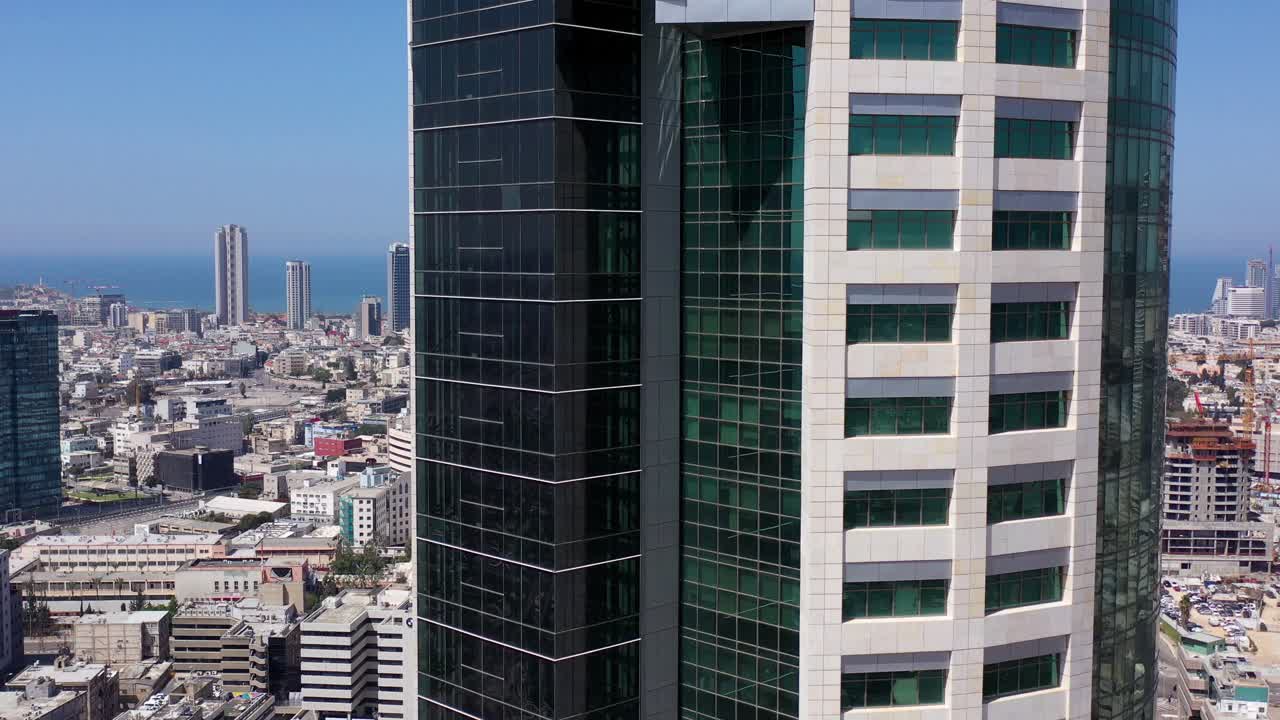 Modern skyscraper in an urban cityscape with a view of the sea