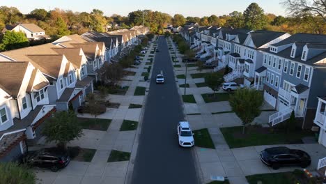 symmetrical townhouses line a quiet suburban street