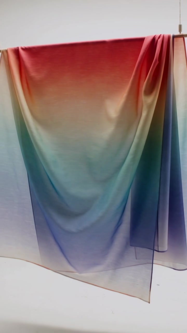 Vertical video: Panning camera showing red-blue panel forming folds in set, rod, cords, back panel