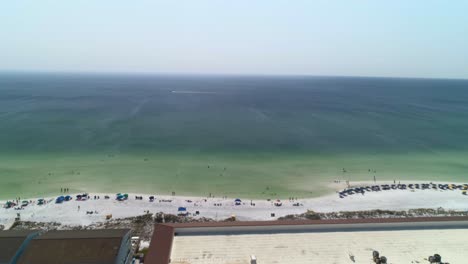 Drone-shot-of-a-beach-front-in-midday-sun