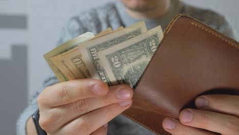 male get us dollar bills from pocket-sized and foldable wallet made of leather