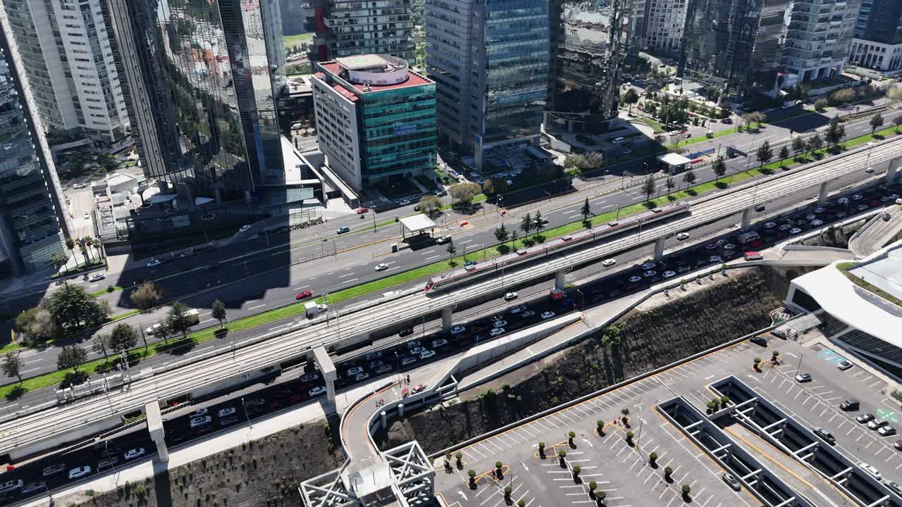Aerial zoom-in of the train pulling into Santa Fe station, CDMX