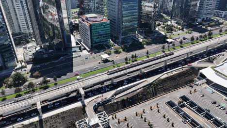 aerial zoom-in of the train pulling into santa fe station, cdmx
