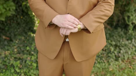 groom-adjusts-watch-on-wedding-day-close-up