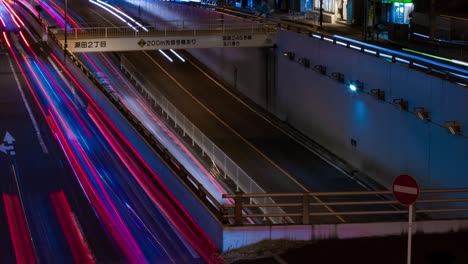 a night timelapse of the traffic jam at the city street in tokyo long shot