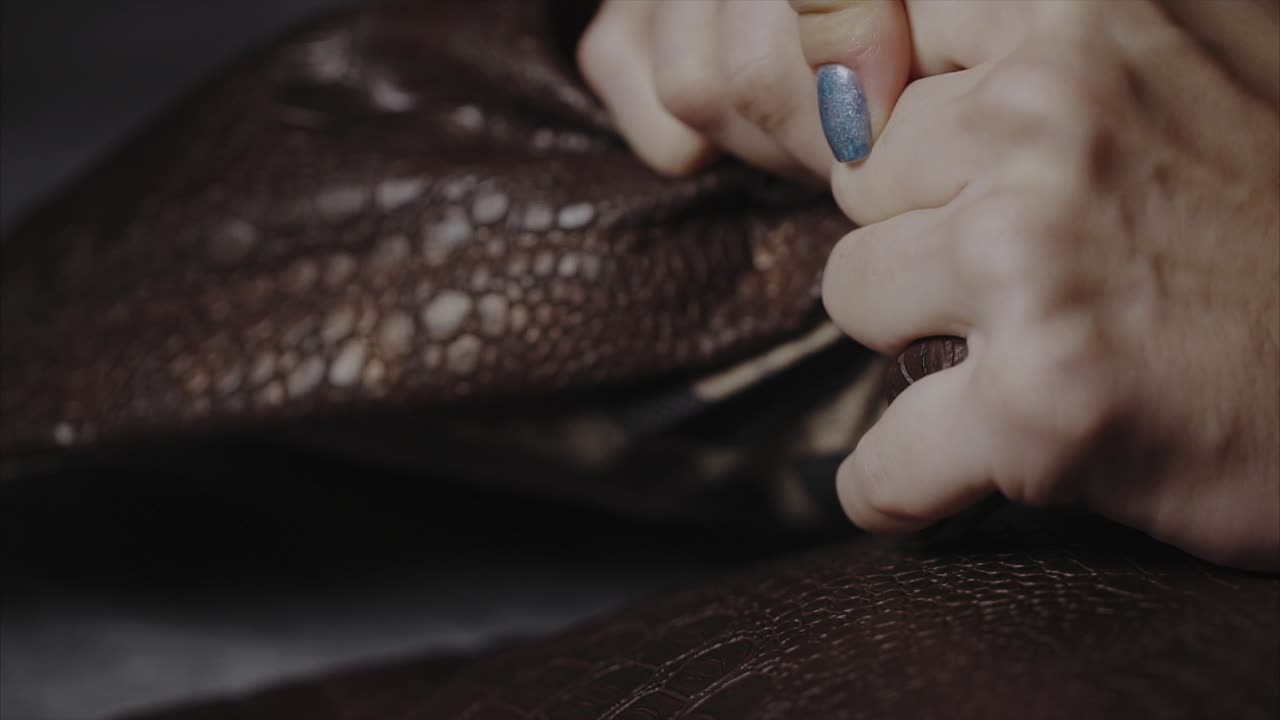 Hands Working on Leather