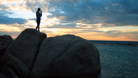 women standing on rock at beach 4k