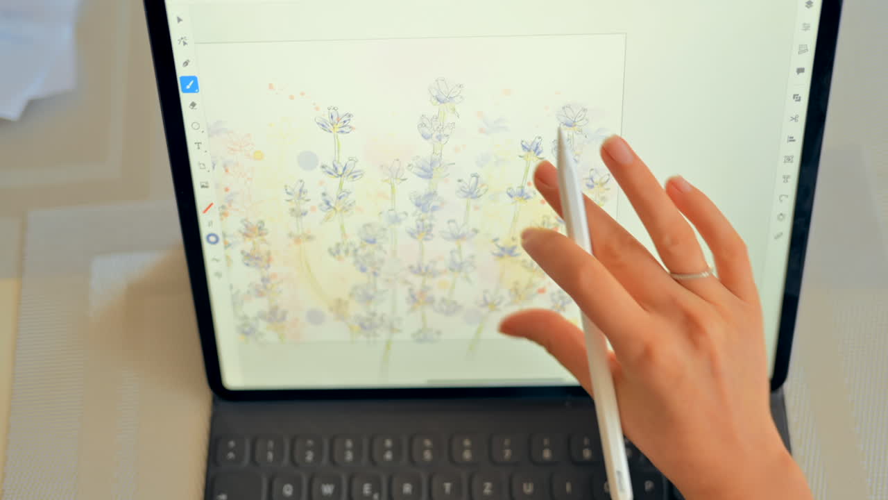 Woman drawing flowers on a tablet with a stylus pen