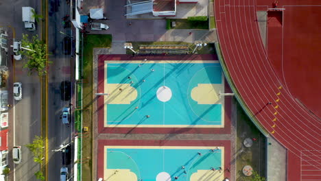 lowering drone shot of basketball courts in the city of playa del carmen mexico