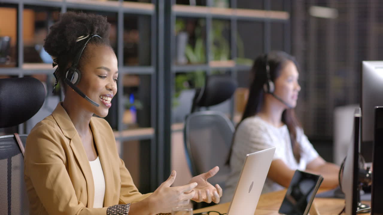 Young African American woman works at her desk in a business office