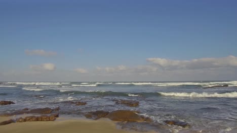 A-closer-look-at-waves-hitting-rocks-on-Glen-Gariff-beach-in-East-London,-South-Africa