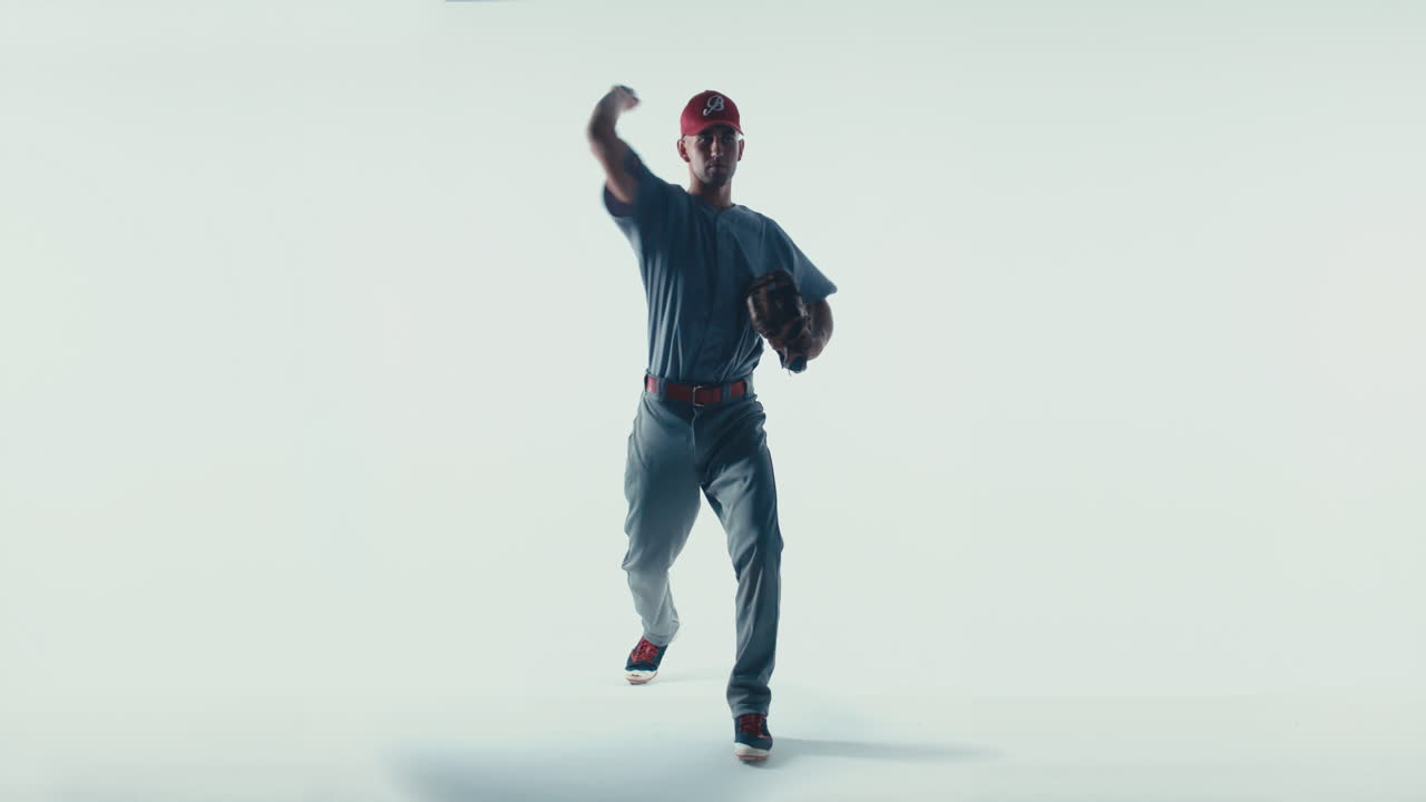 Caucasian professional baseball player pitcher throwing a ball towards camera isolated on white background. 4K UHD 60 FPS SLOW MOTION