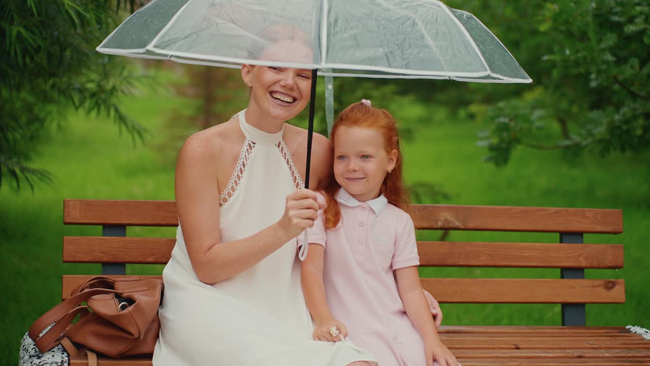 Mother and Daughter Enjoying a Rainy Day in the Park
