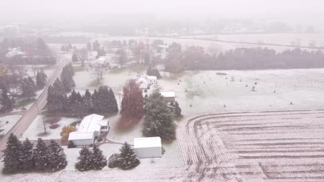 Slow-motion-backward-shot-of-the-place-Snowy-Countryside,-Southeast-Michigan-of-frozen-trees-and-buildings-in-USA