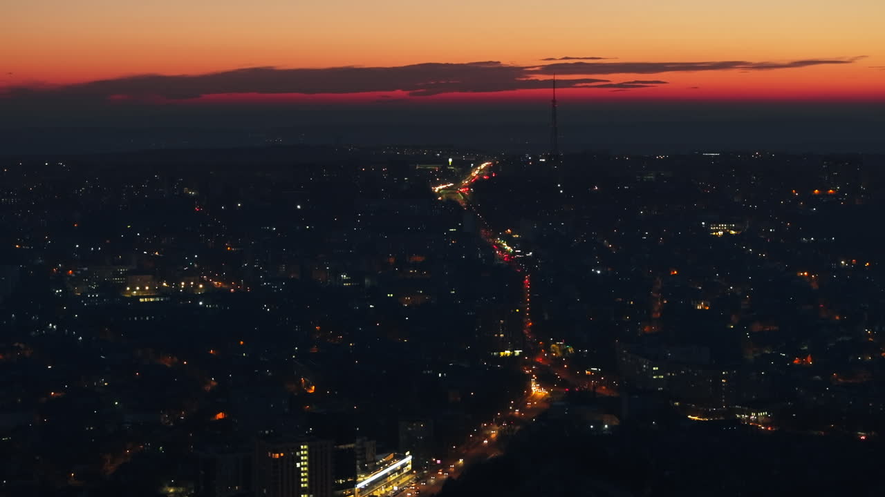 Aerial drone view of Chisinau city with moving traffic at sunset