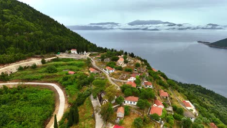 drone flight from high above the monastery in ithaca greece shows rural charm with forest and hilly landscapes