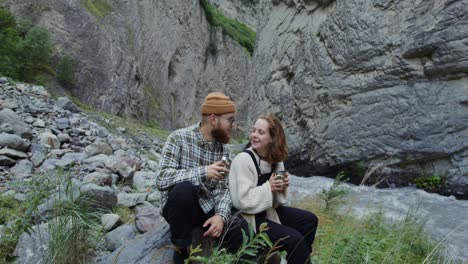 couple relaxing by a mountain river