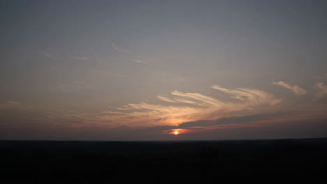 dramatic sunset sky over dark landscape