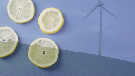animation of lemon slices overlaying landscape with wind turbine in background