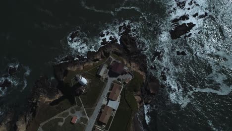 drone shot looking down on a old california coastal light house