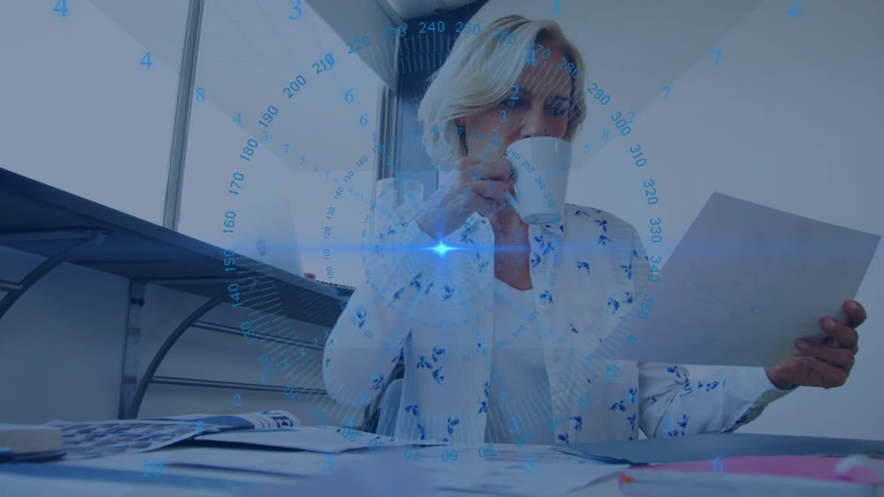 Mature woman picking up mug and sipping coffee while analyzing business report under data overlay