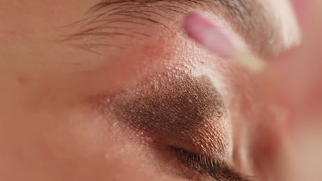 applying eye shadow with cotton swabs