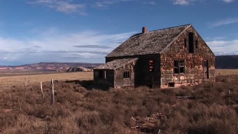 medium shot of an old abandoned homestead a lonely prairie