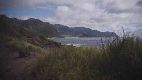 a cinematic shot of hawaiian mountains on the coast in 4k - slow motion.