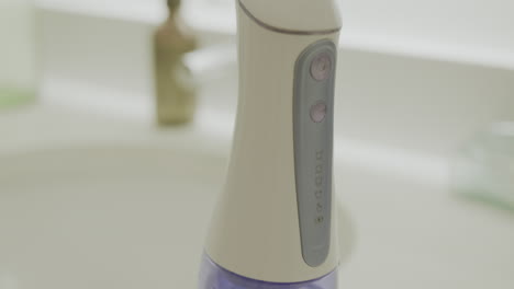 close up tilt up of a water flosser