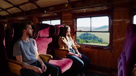 couple enjoying a scenic train ride through the countryside