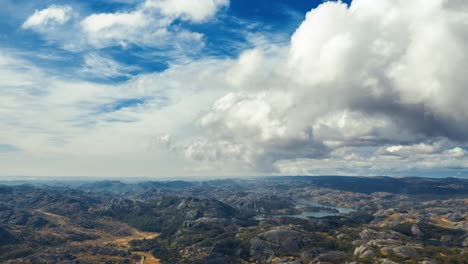 Clouds-passing-and-swirling-over-the-tundra-around-Veltlandske-hovedvei,-Norway