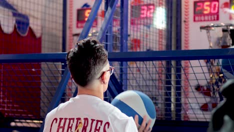 person playing basketball arcade game enthusiastically